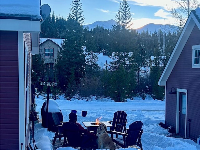 38 Huckleberry Grn, Breckenridge, CO 80424 - snow covered patio with an outdoor fire pit and a mountain view