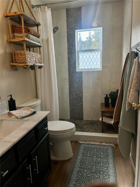 38 Huckleberry Grn, Breckenridge, CO 80424 - bathroom with wood finished floors, a tile shower, and vanity