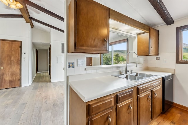 361 Lagoon Ln, Silverthorne, CO 80498 - kitchen featuring a sink, black dishwasher, light wood-style floors, backsplash, and light countertops