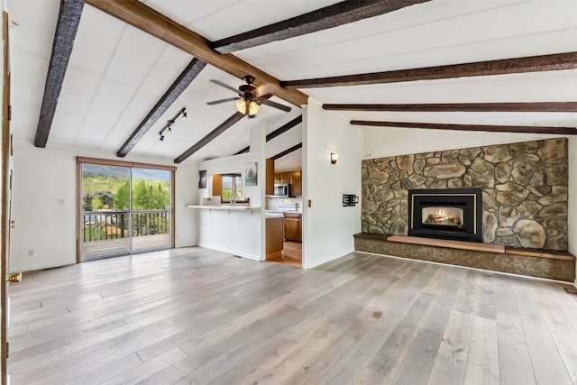 361 Lagoon Ln, Silverthorne, CO 80498 - unfurnished living room featuring a fireplace, light wood-style floors, and a ceiling fan