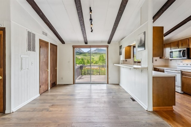 361 Lagoon Ln, Silverthorne, CO 80498 - kitchen with electric stove, stainless steel microwave, light countertops, and light wood-style floors