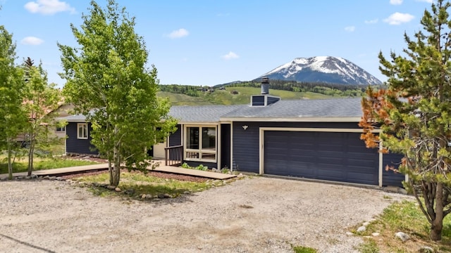 361 Lagoon Ln, Silverthorne, CO 80498 - single story home with a mountain view, dirt driveway, and an attached garage