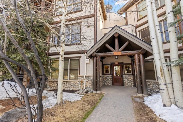 33 Broken Lance Dr Unit 100S, Breckenridge, CO 80424 - view of exterior entry featuring stone siding and stucco siding