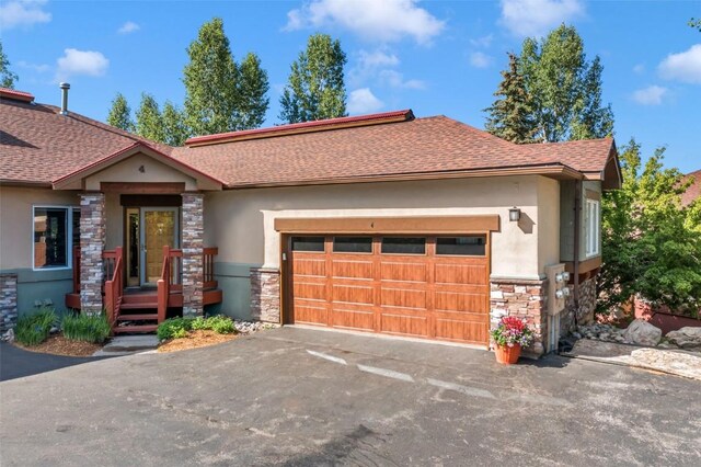 1508 Cascades Dr Unit 4, Steamboat Springs, CO 80487 - view of front facade with stone siding, stucco siding, and roof with shingles