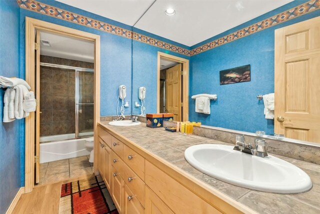 1508 Cascades Dr Unit 4, Steamboat Springs, CO 80487 - bathroom with double vanity and shower / bath combination with glass door