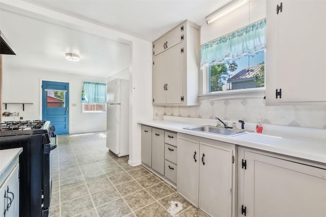 190 N Walnut St, Hayden, CO 81639 - kitchen with freestanding refrigerator, gas stove, and light countertops