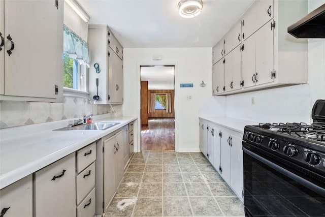 190 N Walnut St, Hayden, CO 81639 - kitchen featuring black range with gas cooktop, range hood, light countertops, and white cabinetry