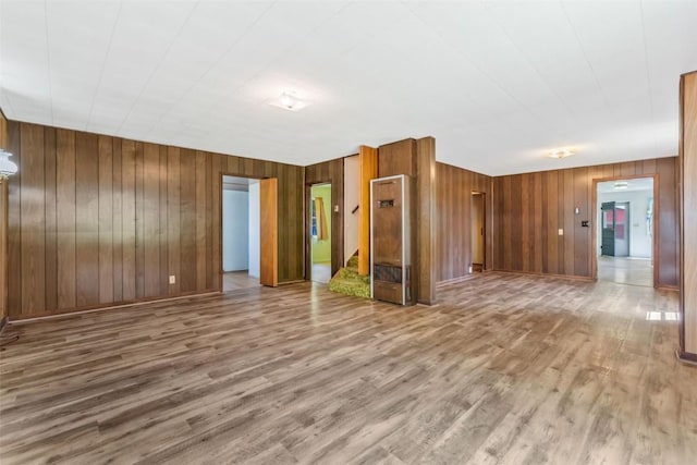 190 N Walnut St, Hayden, CO 81639 - empty room with a heating unit, wood walls, and wood finished floors