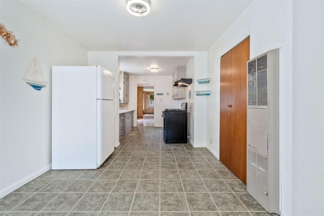 190 N Walnut St, Hayden, CO 81639 - kitchen with freestanding refrigerator, stove, a heating unit, light countertops, and light tile patterned floors