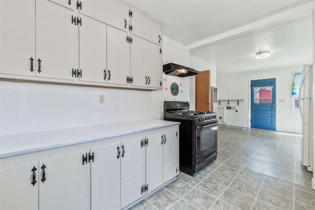 190 N Walnut St, Hayden, CO 81639 - kitchen featuring black gas range, light countertops, wall chimney exhaust hood, white cabinets, and freestanding refrigerator