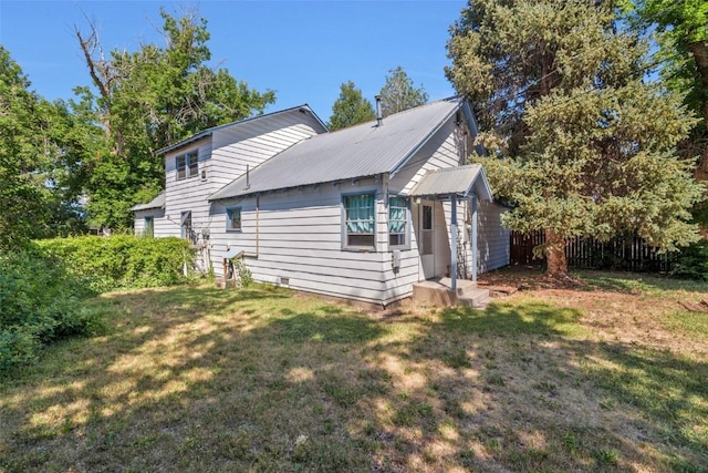 190 N Walnut St, Hayden, CO 81639 - view of side of home with a yard and a metal roof