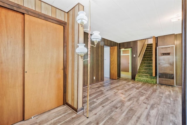 190 N Walnut St, Hayden, CO 81639 - hallway featuring stairway, light wood-style floors, wood walls, and a heating unit