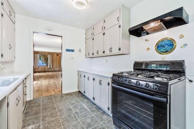 190 N Walnut St, Hayden, CO 81639 - kitchen with black gas range, ventilation hood, white cabinets, and light countertops
