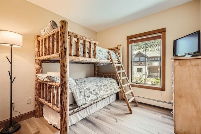 22787 US Highway 6 Unit 313, Keystone, CO 80435 - bedroom with wood finished floors, baseboard heating, and baseboards