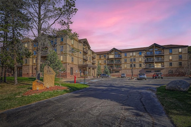 22787 US Highway 6 Unit 313, Keystone, CO 80435 - property at dusk featuring uncovered parking and a view of apartment building / complex