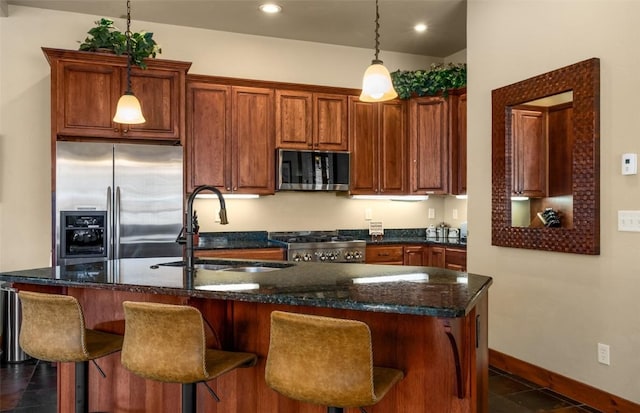 1532 Moraine Cir Unit 40, Steamboat Springs, CO 80487 - kitchen with a sink, a center island with sink, stove, stainless steel fridge with ice dispenser, and decorative light fixtures