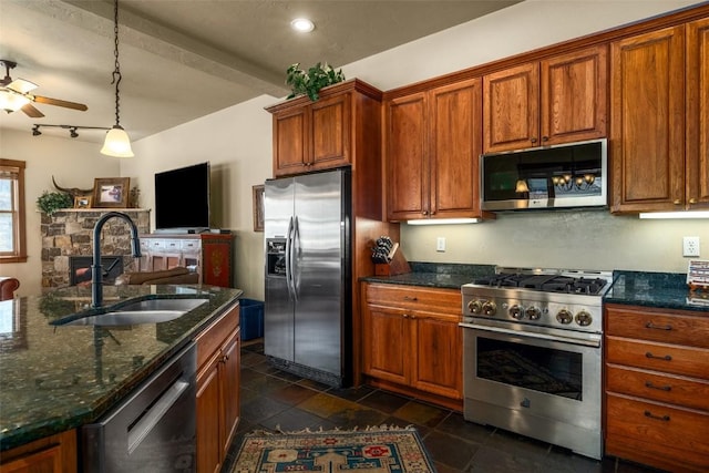 1532 Moraine Cir Unit 40, Steamboat Springs, CO 80487 - kitchen featuring ceiling fan, brown cabinets, stainless steel appliances, and a sink