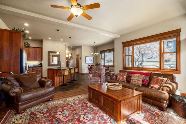 1532 Moraine Cir Unit 40, Steamboat Springs, CO 80487 - living room featuring dark wood-style floors, beam ceiling, baseboards, recessed lighting, and ceiling fan with notable chandelier