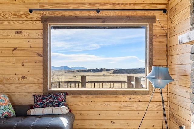 interior space featuring wooden walls and a mountain view