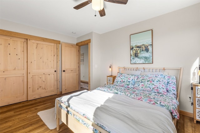 bedroom with baseboards, a ceiling fan, and wood finished floors