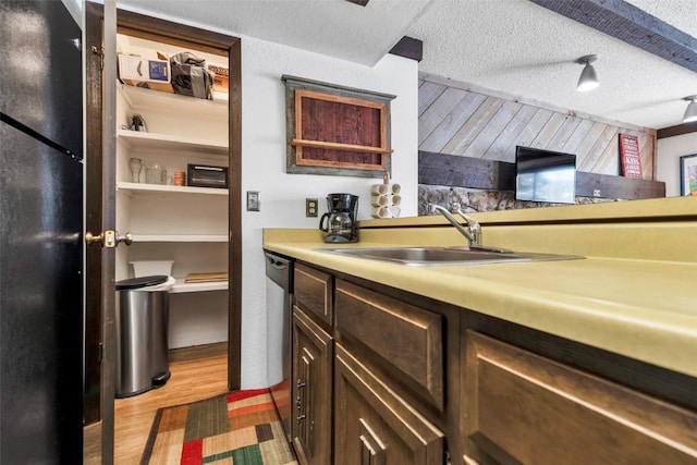 107 N Harris St Unit 209, Breckenridge, CO 80424 - kitchen featuring a sink, a textured ceiling, light wood finished floors, light countertops, and freestanding refrigerator