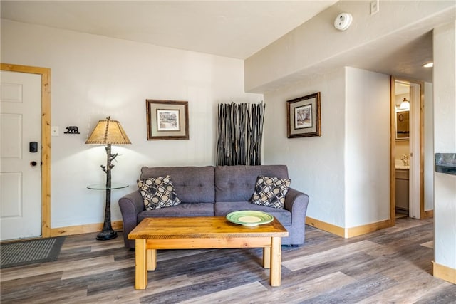 living area featuring wood finished floors and baseboards
