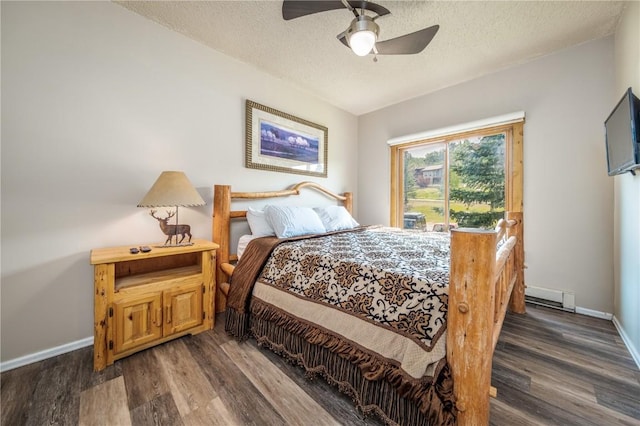 bedroom featuring a ceiling fan, baseboards, a baseboard radiator, a textured ceiling, and dark wood-style flooring