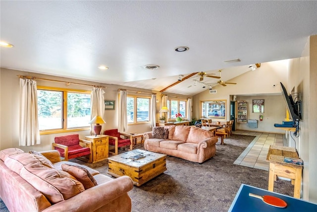 living area featuring lofted ceiling, visible vents, a ceiling fan, and carpet