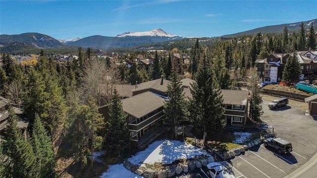 aerial view featuring a forest view and a mountain view