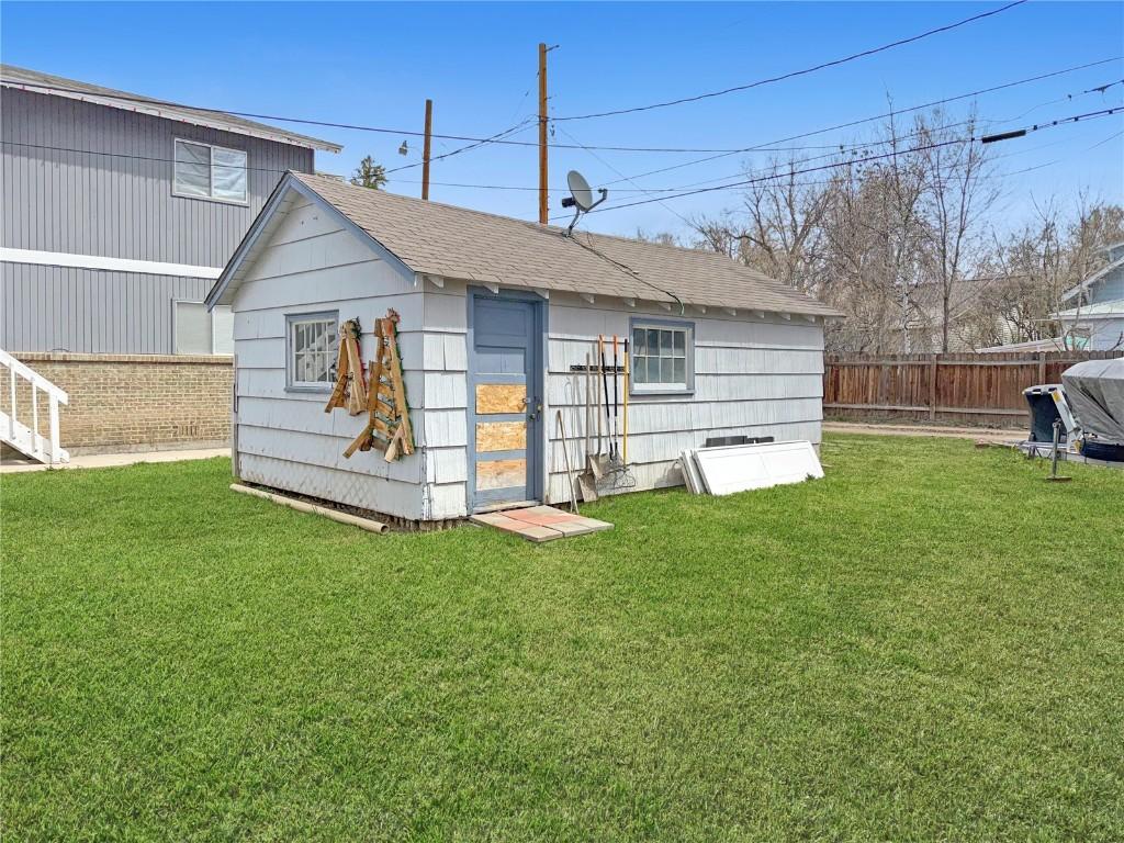 view of outbuilding with a fenced backyard and an outbuilding
