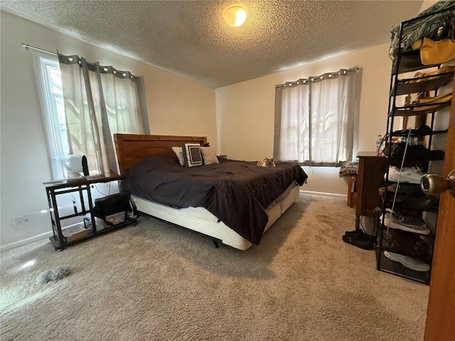 635 School St, Craig, CO 81625 - carpeted bedroom featuring a textured ceiling and baseboards