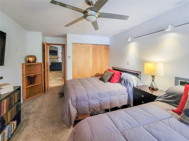72 Corinthian Cir Unit 303, Dillon, CO 80435 - bedroom featuring a closet, a textured ceiling, carpet floors, and a ceiling fan