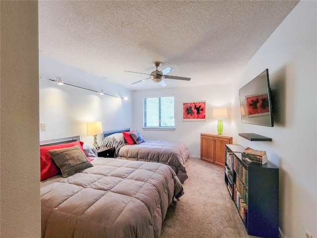 72 Corinthian Cir Unit 303, Dillon, CO 80435 - bedroom featuring a textured ceiling, light colored carpet, track lighting, and a ceiling fan