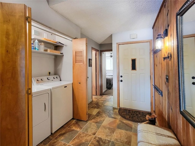 72 Corinthian Cir Unit 303, Dillon, CO 80435 - washroom featuring washing machine and dryer, a textured ceiling, and dark stone finish floors