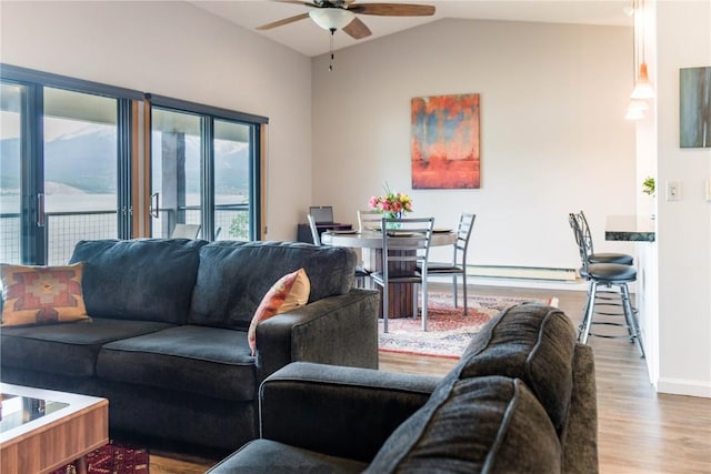 72 Corinthian Cir Unit 303, Dillon, CO 80435 - living room featuring ceiling fan, wood finished floors, lofted ceiling, and baseboard heating
