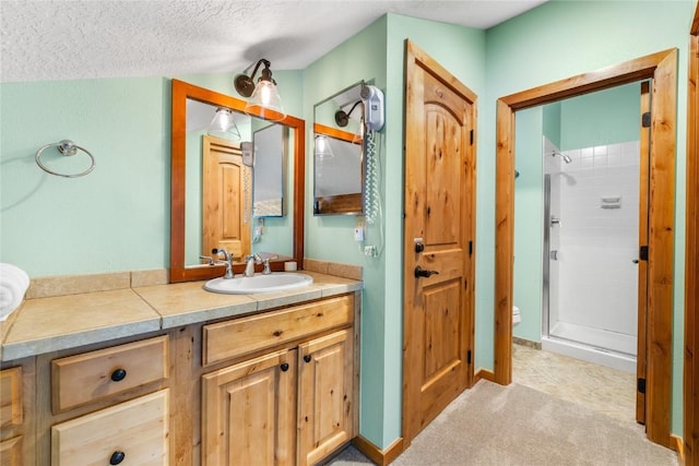 22300 US Highway 6 Unit 1746, Keystone, CO 80435 - full bath featuring a stall shower, vanity, and a textured ceiling