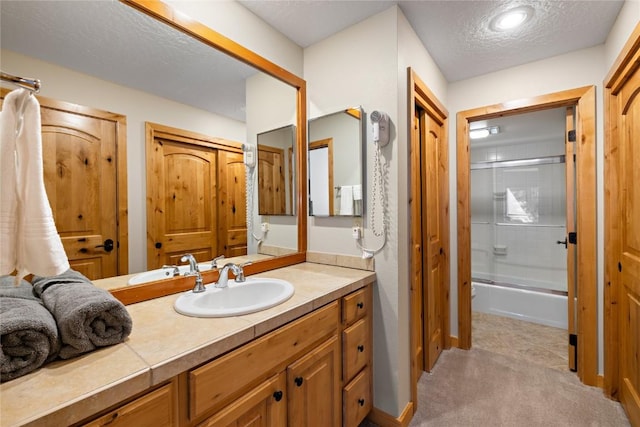 22300 US Highway 6 Unit 1746, Keystone, CO 80435 - full bathroom with vanity, shower / bath combination with glass door, and a textured ceiling