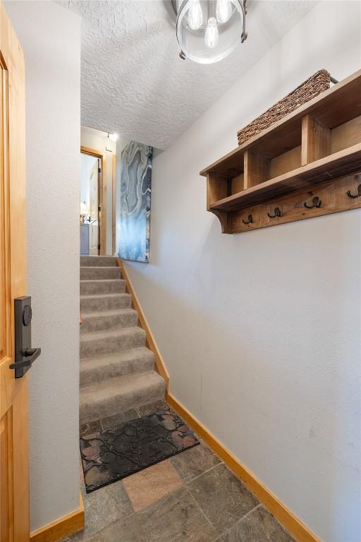 22300 US Highway 6 Unit 1746, Keystone, CO 80435 - mudroom with baseboards and a textured ceiling