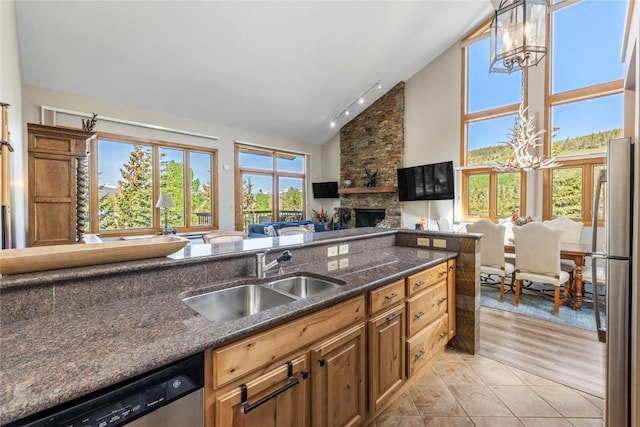 22300 US Highway 6 Unit 1746, Keystone, CO 80435 - kitchen with a chandelier, appliances with stainless steel finishes, a fireplace, open floor plan, and high vaulted ceiling