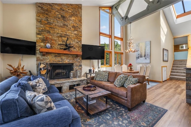 22300 US Highway 6 Unit 1746, Keystone, CO 80435 - living room featuring high vaulted ceiling, a chandelier, stairs, wood finished floors, and a fireplace