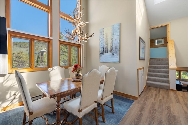 22300 US Highway 6 Unit 1746, Keystone, CO 80435 - dining area with wood finished floors, stairway, a high ceiling, and baseboard heating
