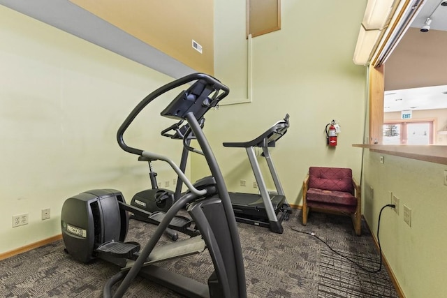 exercise area with baseboards and carpet flooring