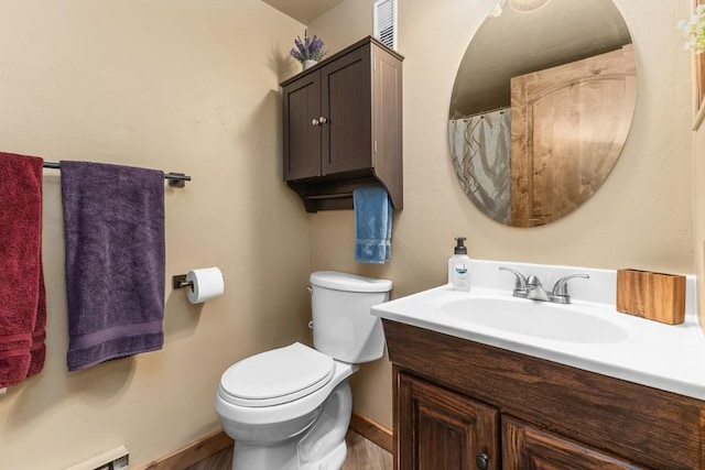 full bathroom with baseboard heating, wood finished floors, vanity, baseboards, and toilet