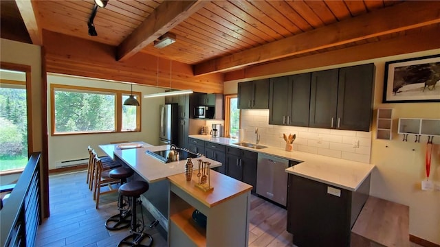 620 Tennis Club Rd Unit 1337, Keystone, CO 80435 - kitchen with stainless steel appliances, a wood ceiling with exposed beams, hardwood / wood-style floors, light countertops, and tasteful backsplash