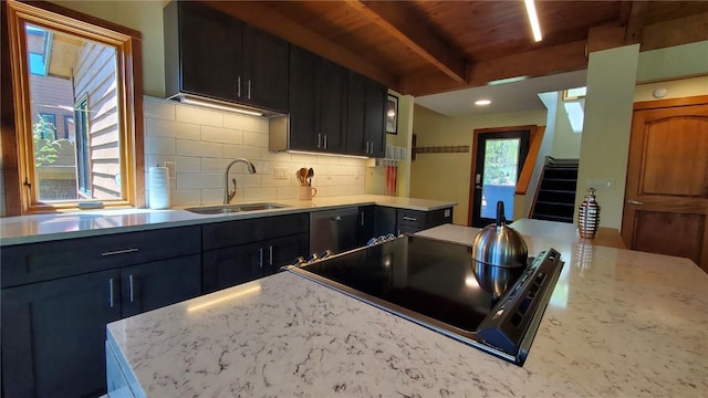 620 Tennis Club Rd Unit 1337, Keystone, CO 80435 - kitchen featuring cooktop, tasteful backsplash, a wooden ceiling with exposed beams, dark cabinets, and light stone counters