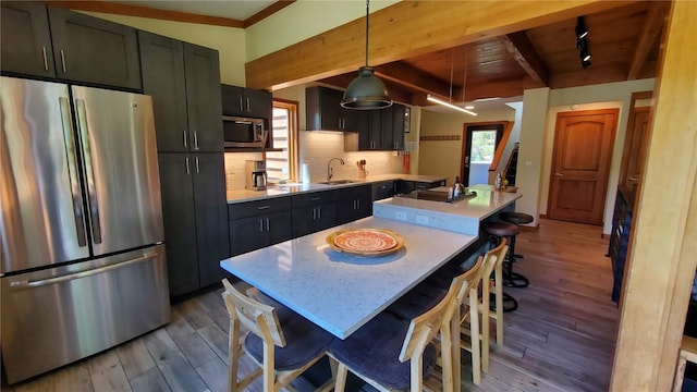 620 Tennis Club Rd Unit 1337, Keystone, CO 80435 - kitchen with appliances with stainless steel finishes, wood finished floors, light countertops, decorative backsplash, and dark cabinetry