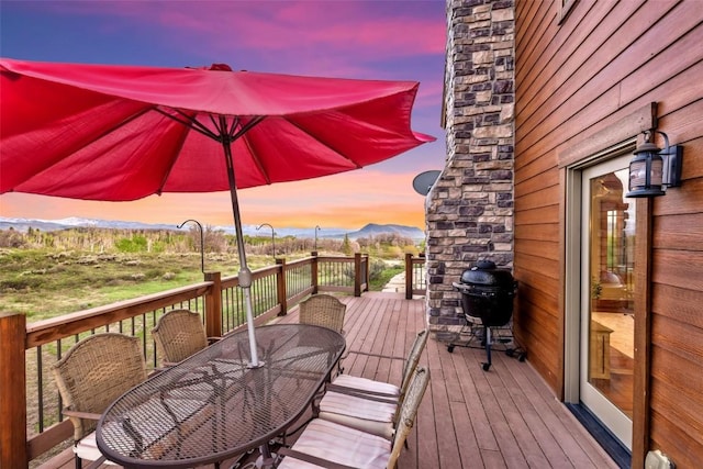 51193 Smith Creek Park Rd, Steamboat Springs, CO 80487 - deck featuring outdoor dining space, a mountain view, and a grill