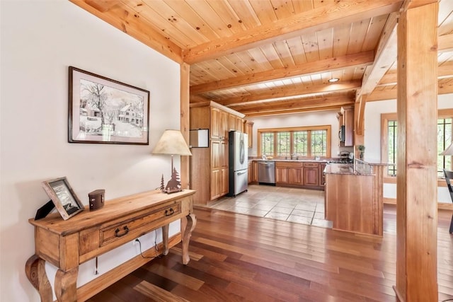 51193 Smith Creek Park Rd, Steamboat Springs, CO 80487 - kitchen with appliances with stainless steel finishes, light wood finished floors, wooden ceiling, beamed ceiling, and brown cabinets