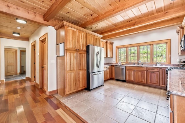 51193 Smith Creek Park Rd, Steamboat Springs, CO 80487 - kitchen with stainless steel appliances, beam ceiling, wood ceiling, light stone counters, and a sink