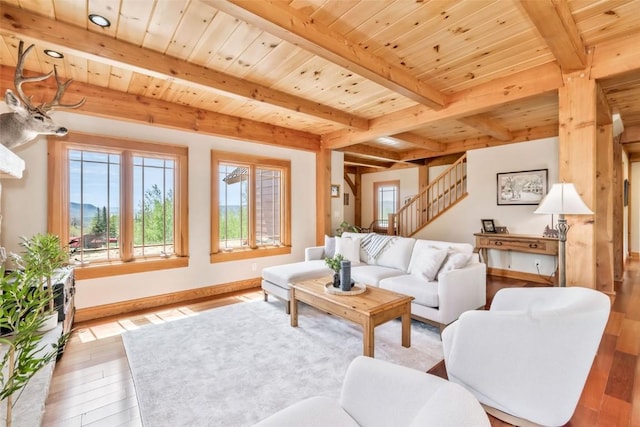 51193 Smith Creek Park Rd, Steamboat Springs, CO 80487 - living area with beamed ceiling, wood finished floors, stairs, wooden ceiling, and baseboards